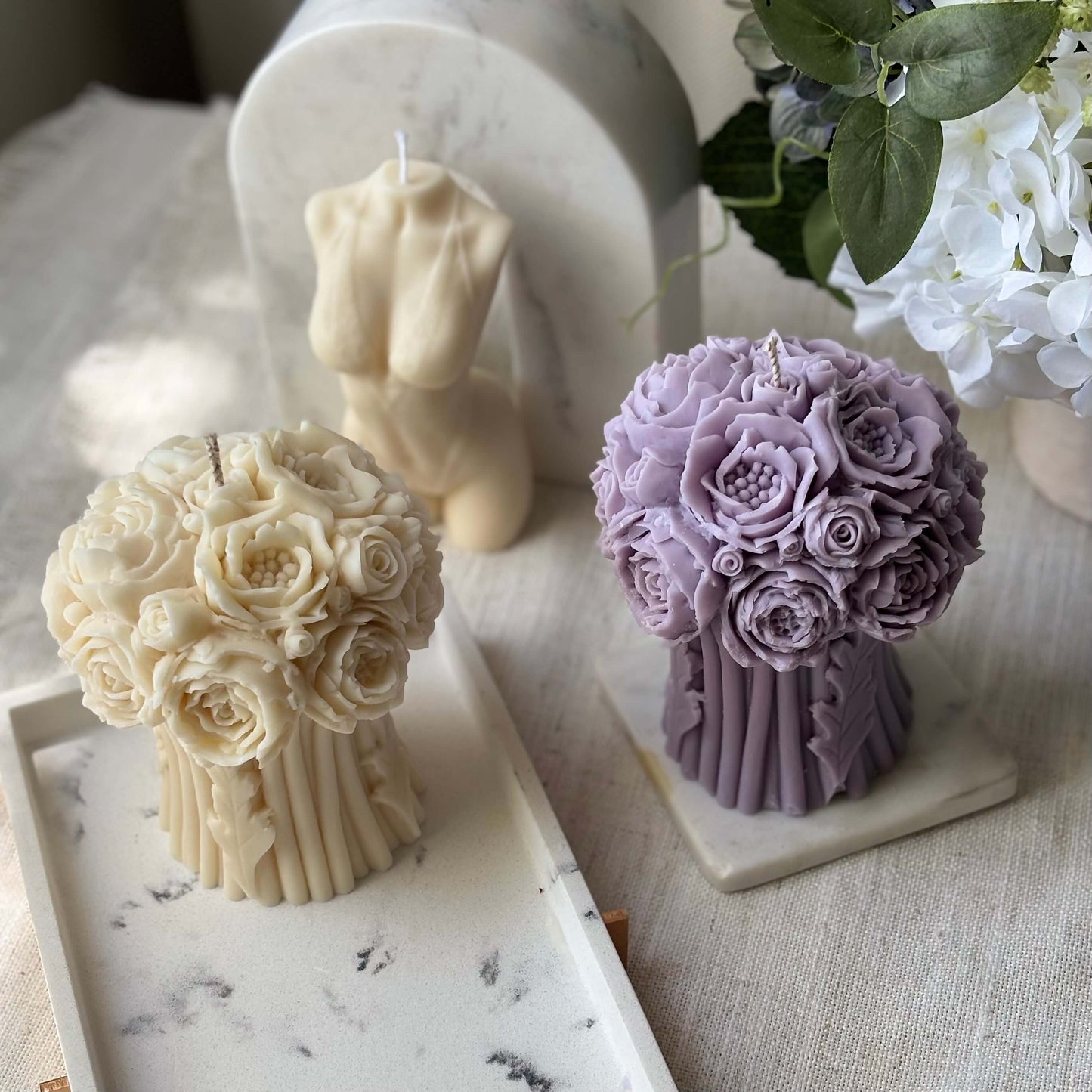 Two handmade soy wax peony bouquet candles in lavender and ivory, luxury floral home decor, centerpiece for weddings and celebrations.