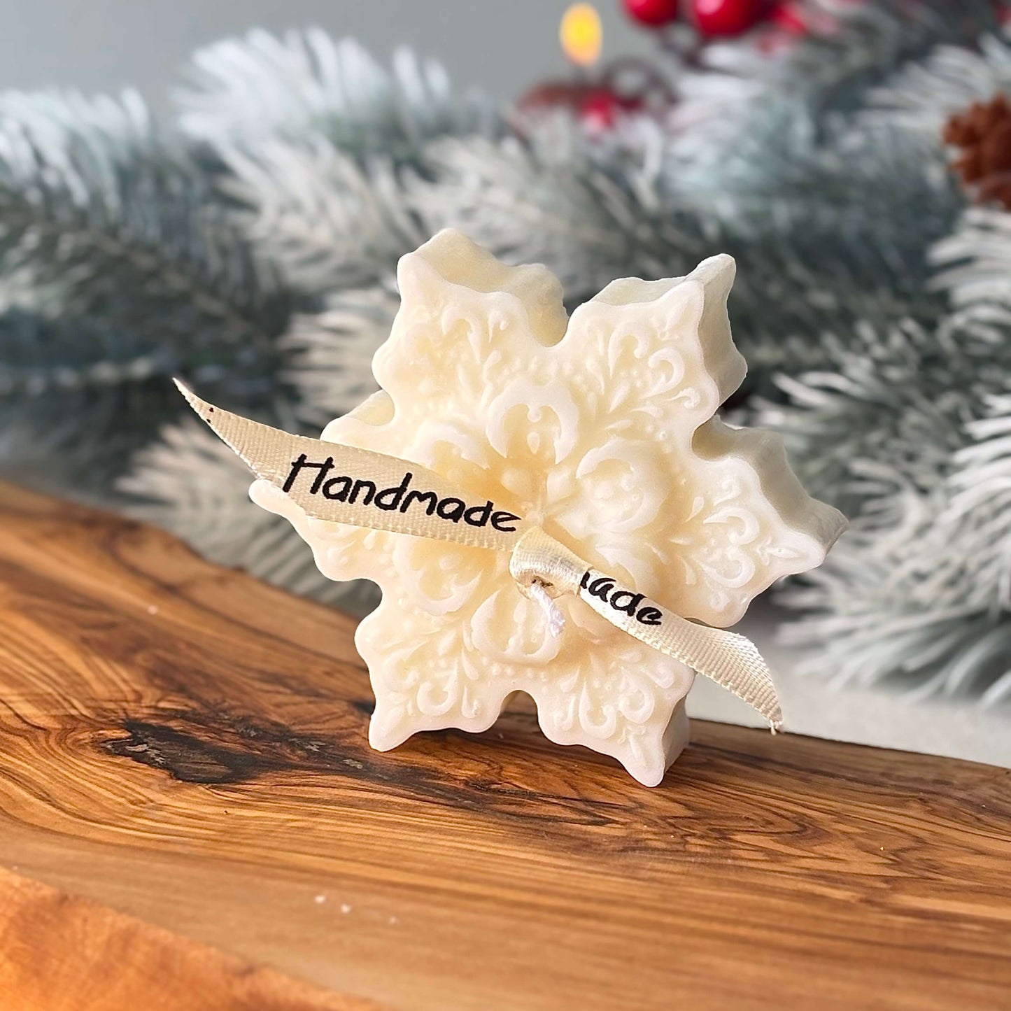 Gift set with eco-friendly snowflake soy candles and green holiday ribbon