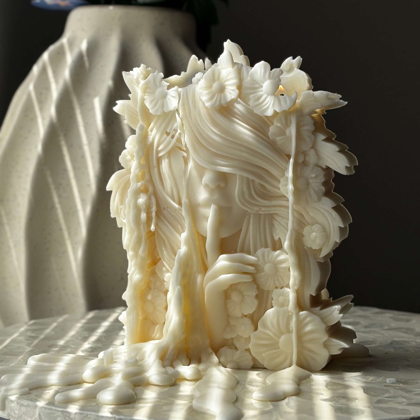 Handcrafted wax art candle in the shape of a floral female sculpture with detailed hair and flowers, ideal for aesthetic interior styling