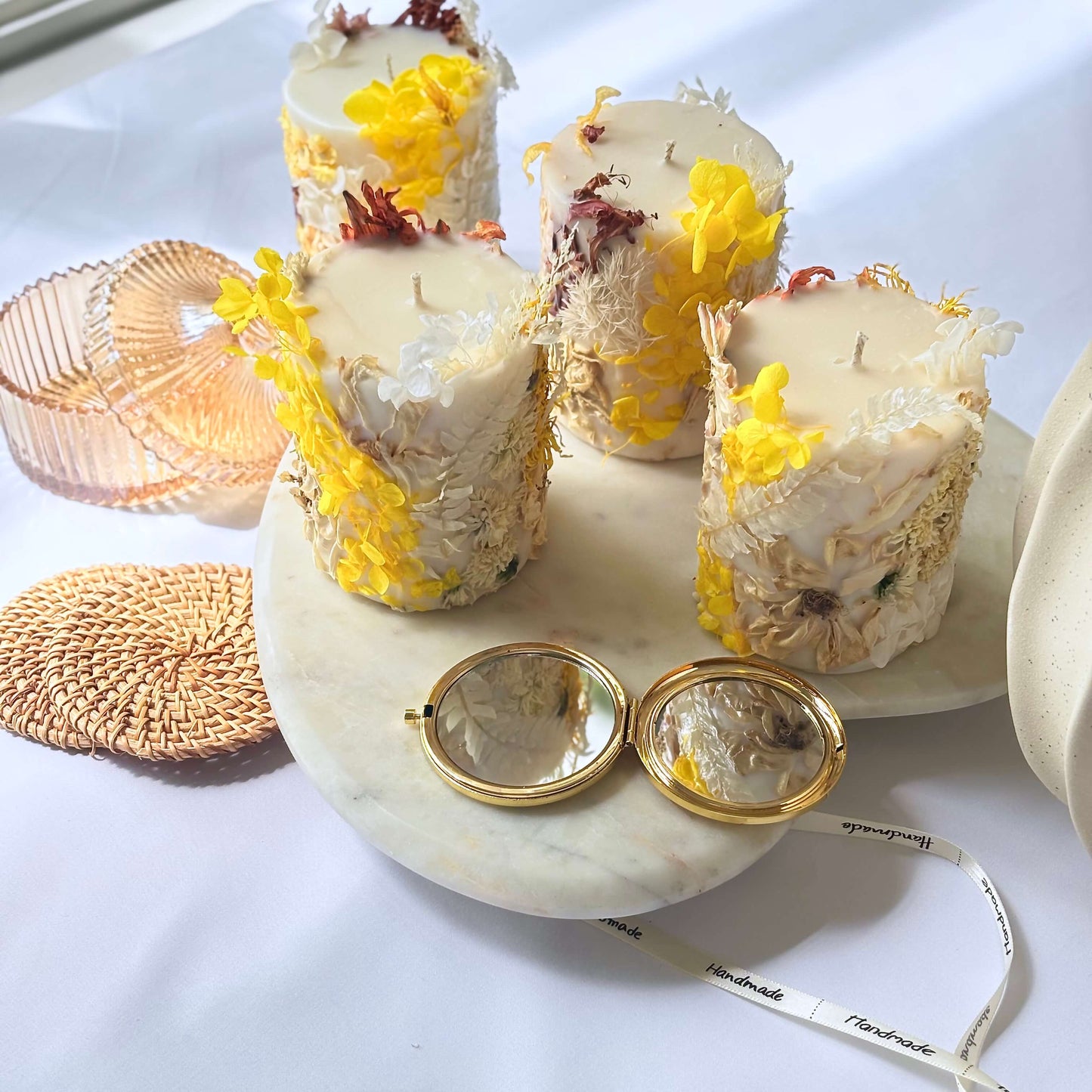 Set of handmade botanical soy candles with yellow flowers and natural decor, displayed on a marble tray — perfect for gifting or spring home styling.