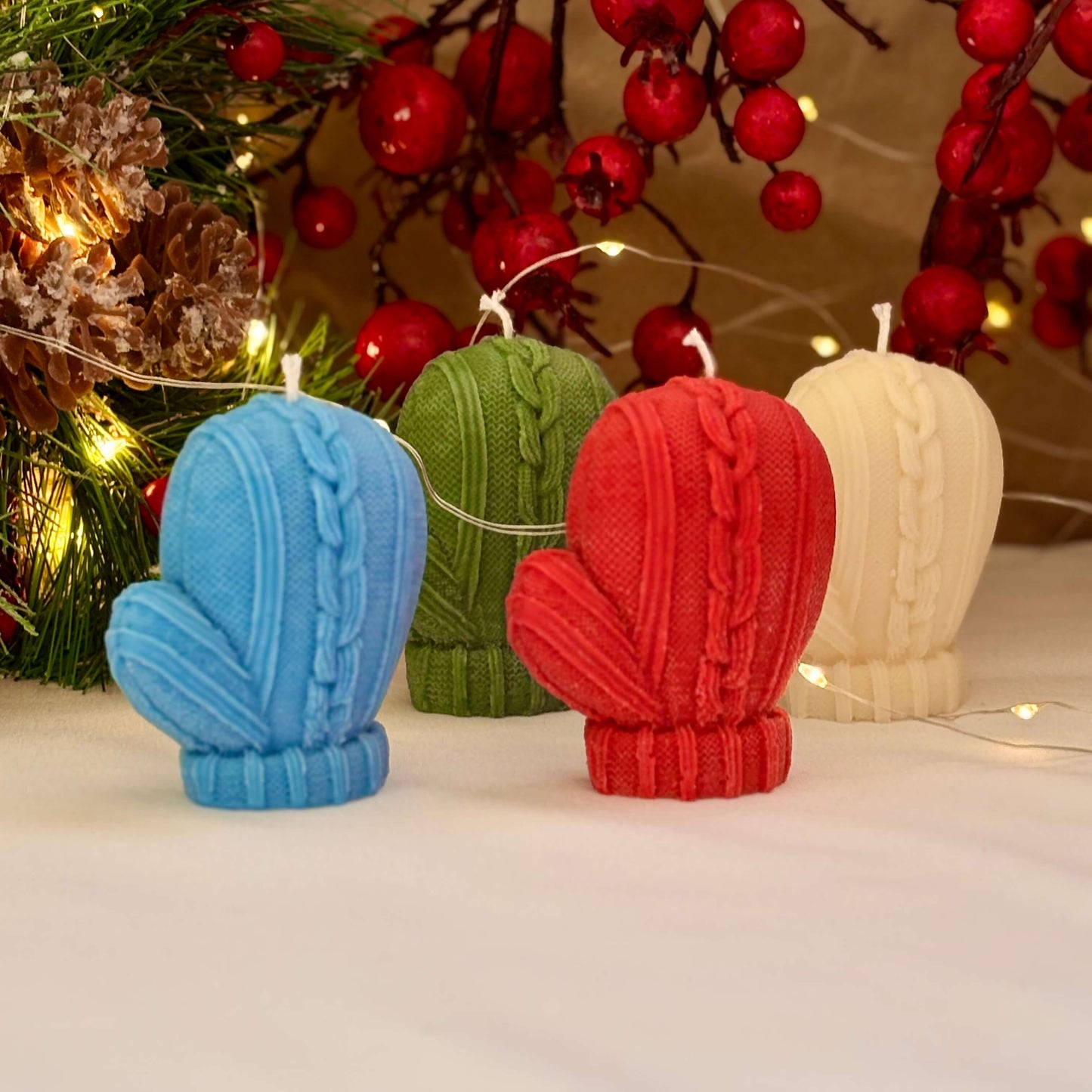 Four cozy mitten candles in festive colors for winter decor or Secret Santa gift idea