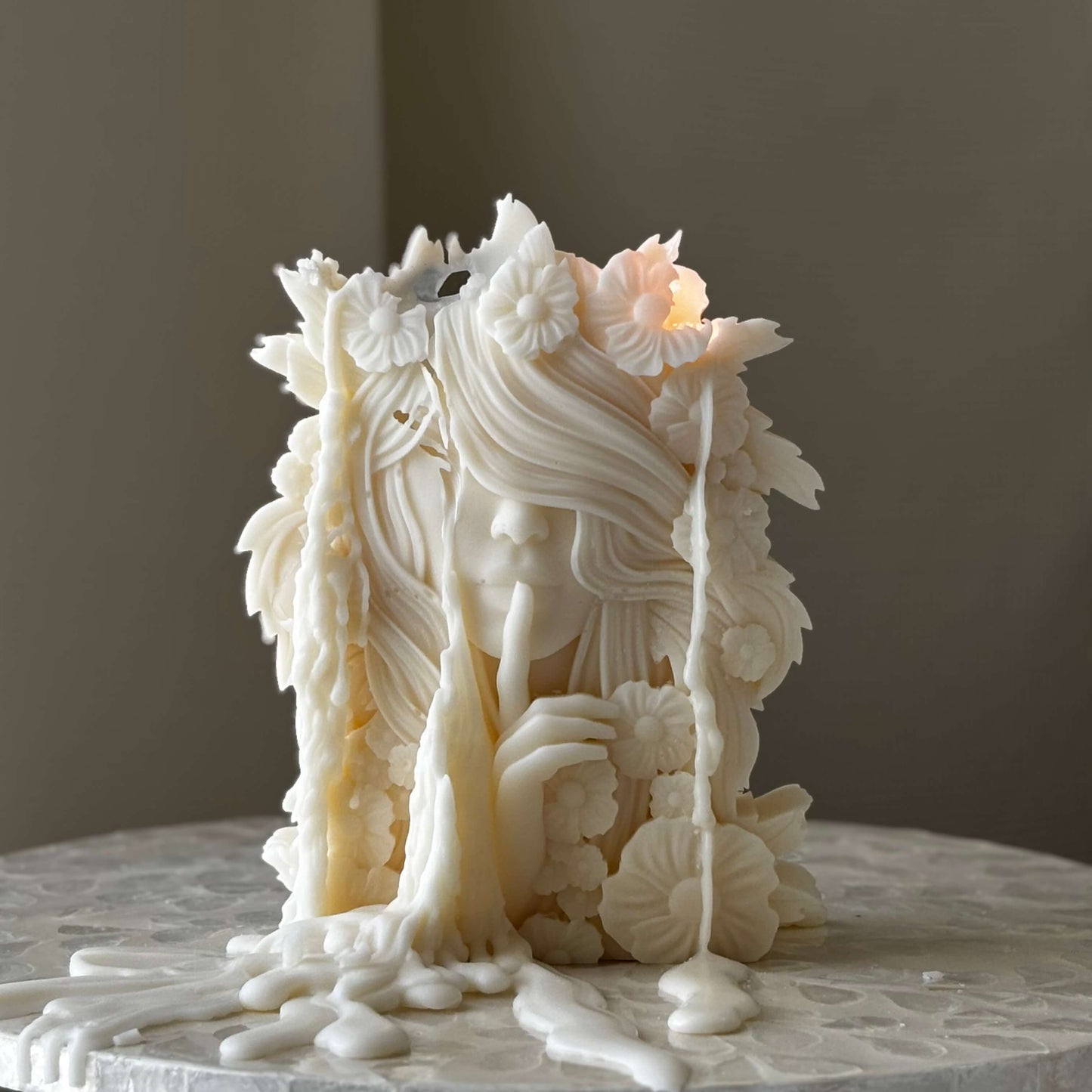 Handmade soy wax candle in the shape of a flower goddess with intricate feminine details and sculptural floral elements, perfect as artistic home decor
