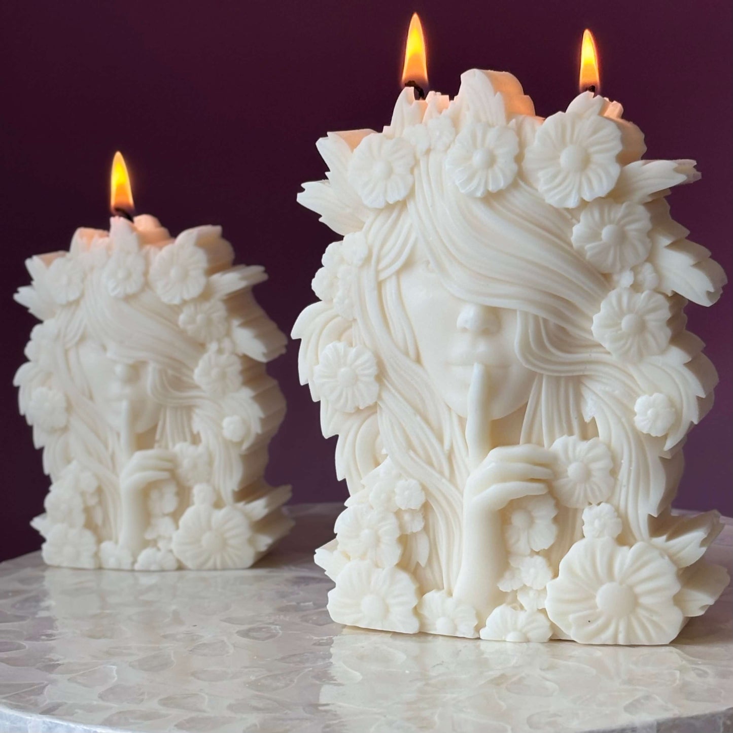 Decorative goddess candles burning with warm glow – handmade floral design