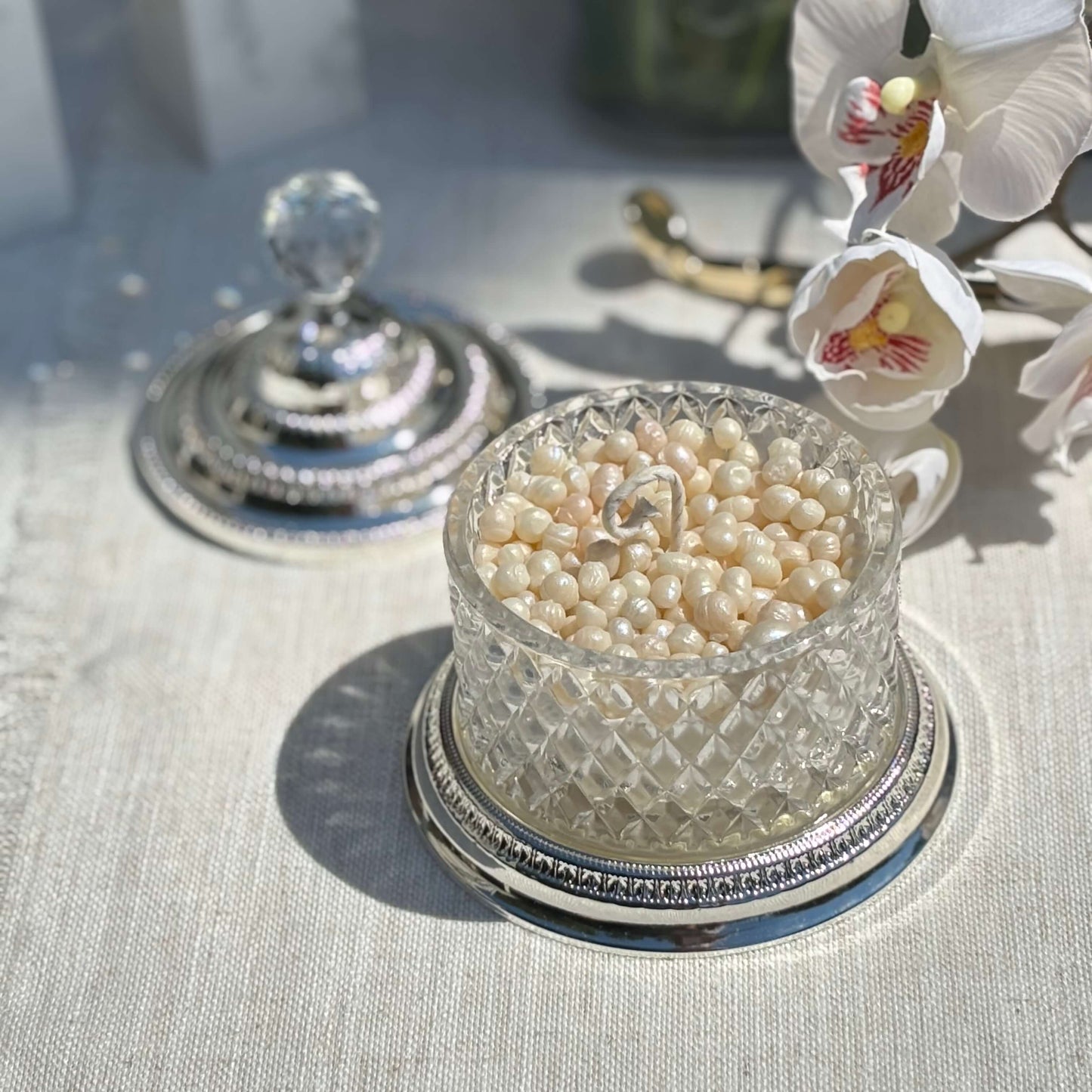 Decorative pearl candle in faceted glass jar with orchid — romantic wedding decoration or gift for mom and sister