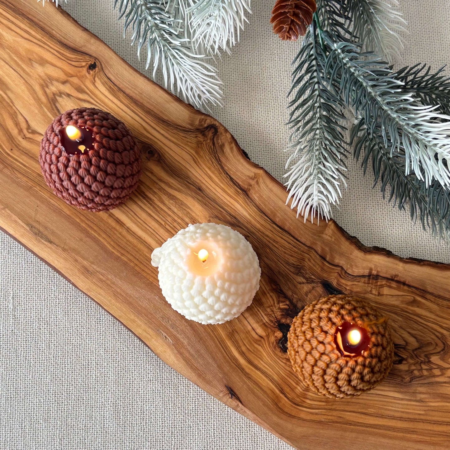 Holiday decorative candle shaped like a pinecone, handmade soy wax design for cozy décor
