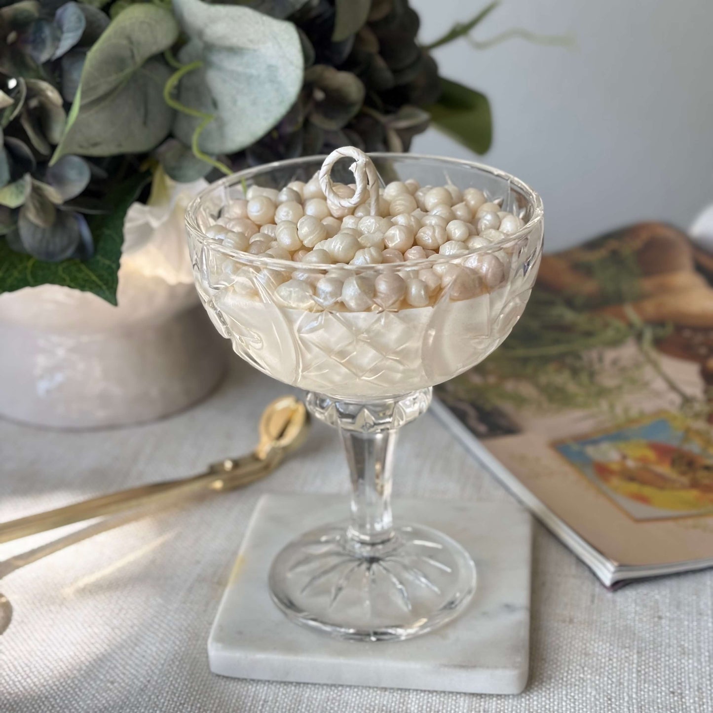 Elegant pearl soy wax candle in glass coupe — luxury home décor and coffee table centerpiece