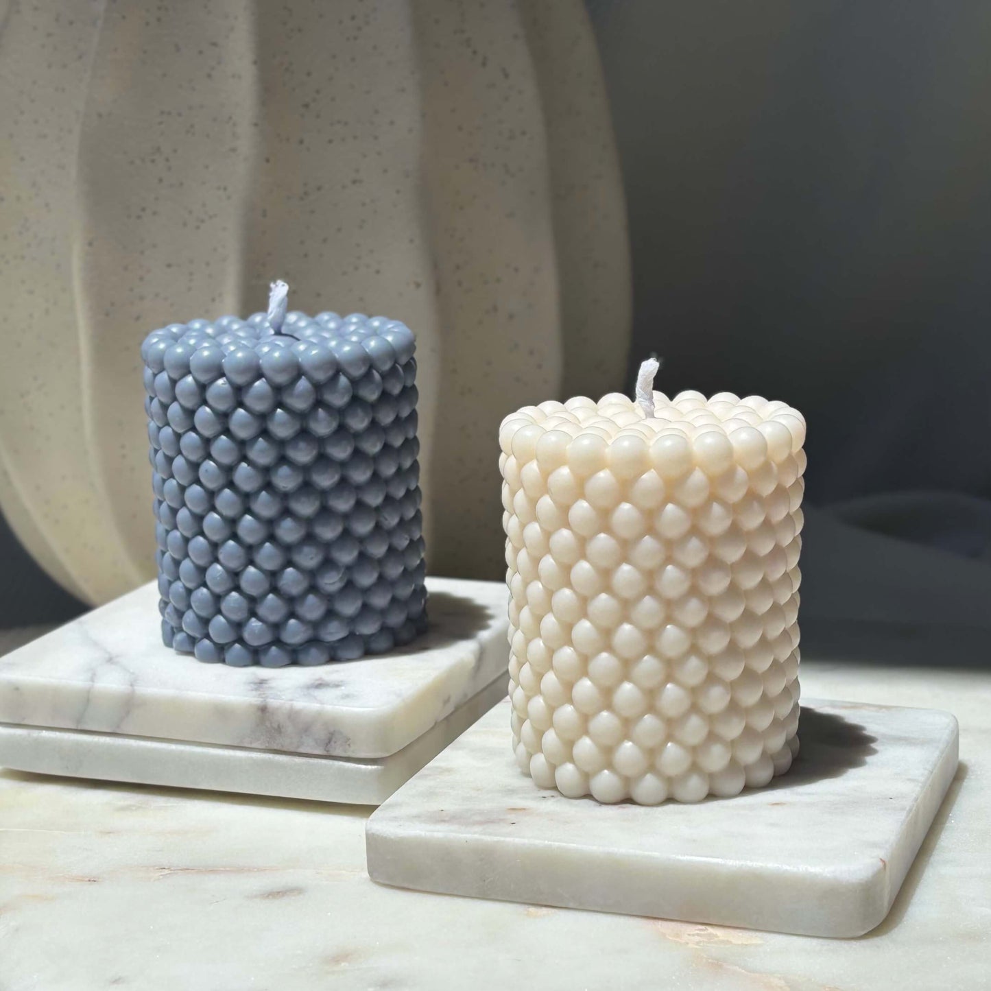 Minimalist wax candle duo in ivory and slate blue — elegant and handcrafted decor for calming spaces.