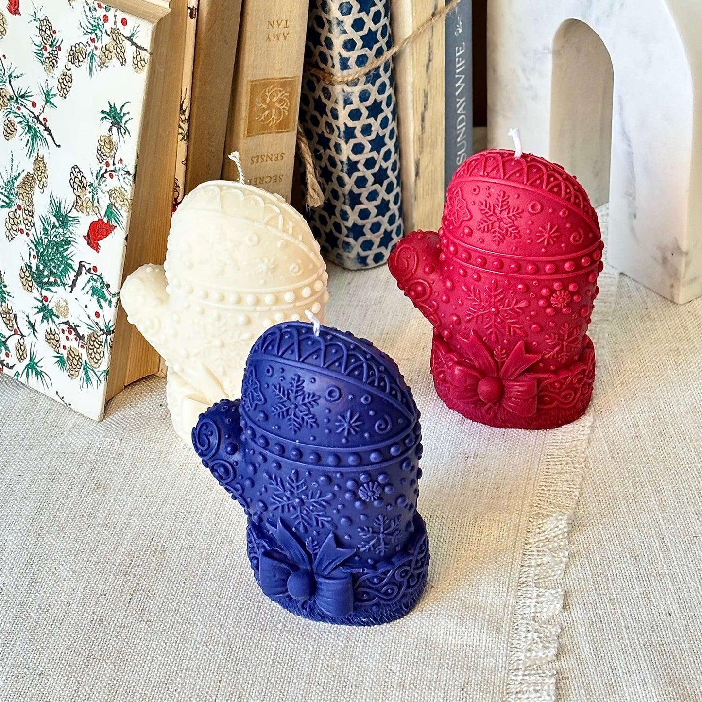 rio of mitten candles in blue, red, and white — handcrafted soy wax, holiday home decor, corporate gift for Christmas or Thanksgiving.