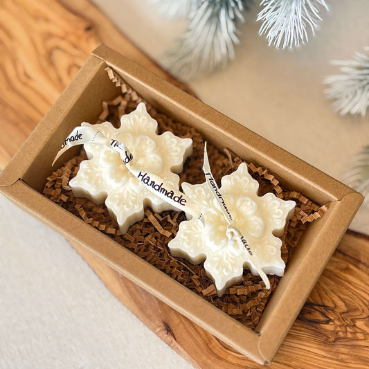 Handmade soy wax snowflake candles in eco-friendly box with festive decor