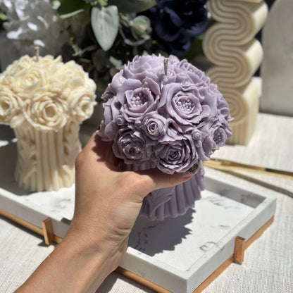 Hand holding a lavender peony bouquet candle, handmade from soy wax, floral sculpture for home decor, wedding gift candle.