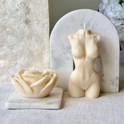 Handmade beige torso candle with rose shaped candle on marble display for luxury gift and home accent