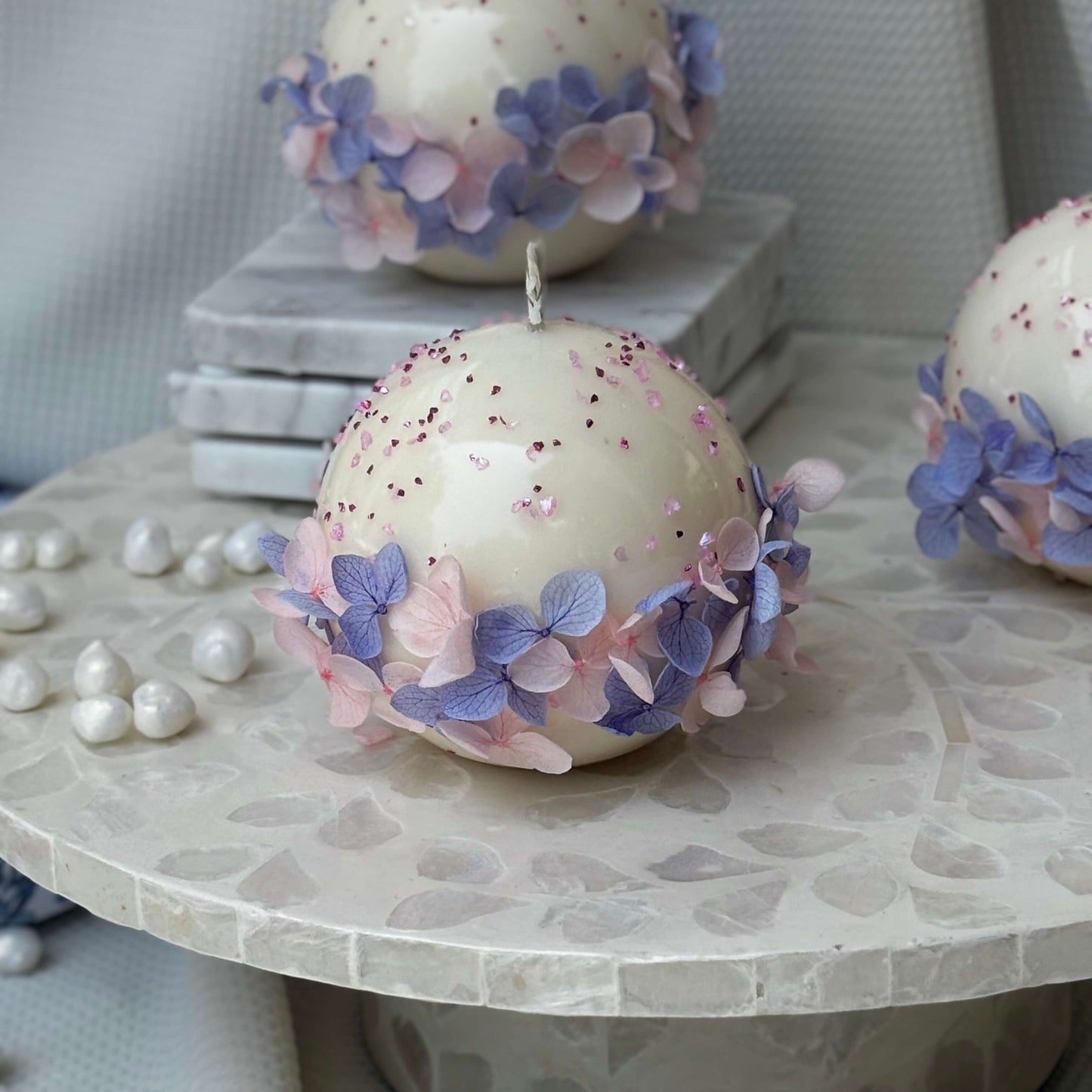 Close-up of three Bloomella decorative soy candles with pearl accents, emphasizing luxury gift appeal.	