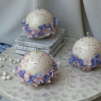Elegant trio of handmade Bloomella soy candles on marble surface — perfect housewarming or bridesmaid gift.	