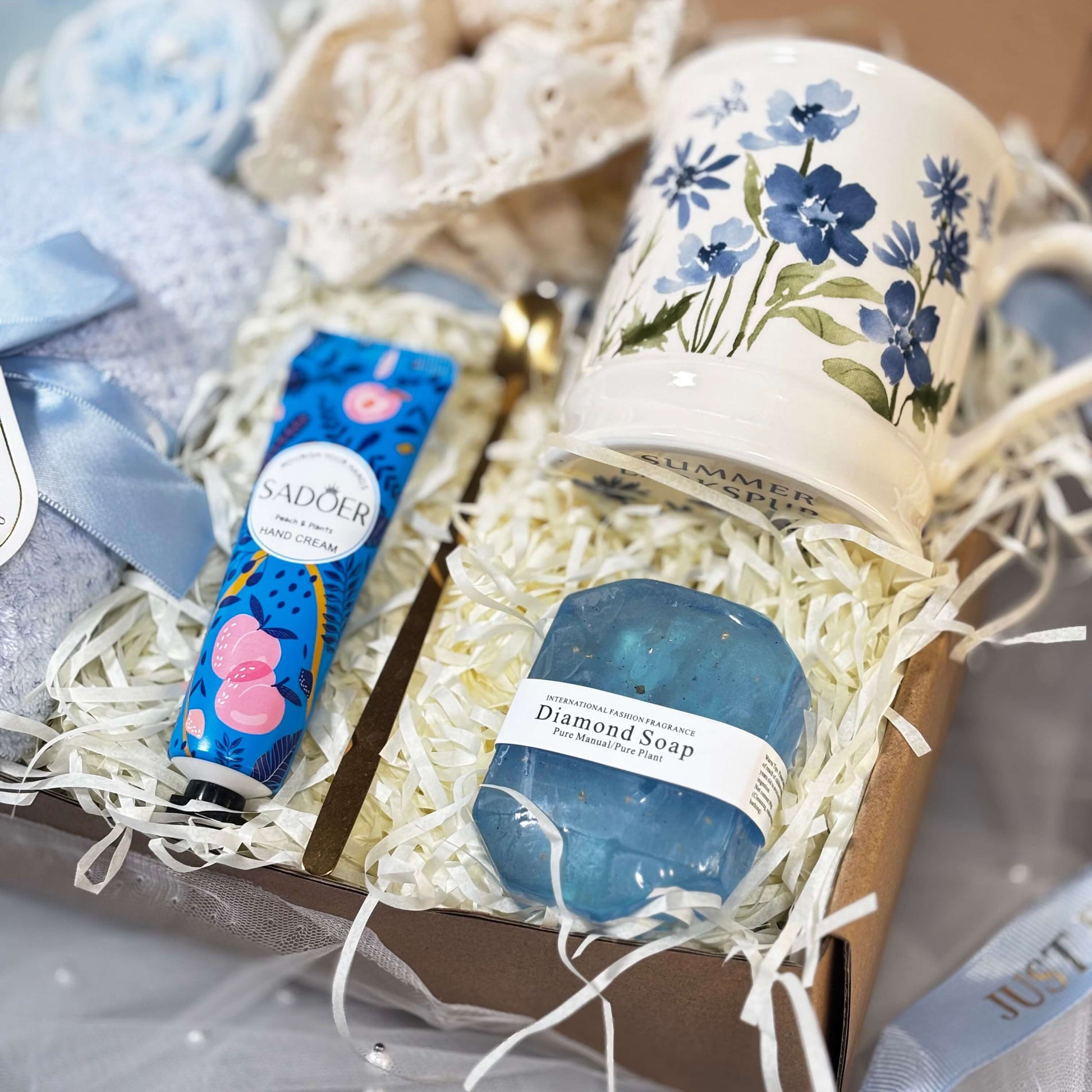 A cozy blue-themed gift box with floral mug, blue diamond soap, and peach hand cream – ideal for self-care moments, spa gifts, and thoughtful surprises.
