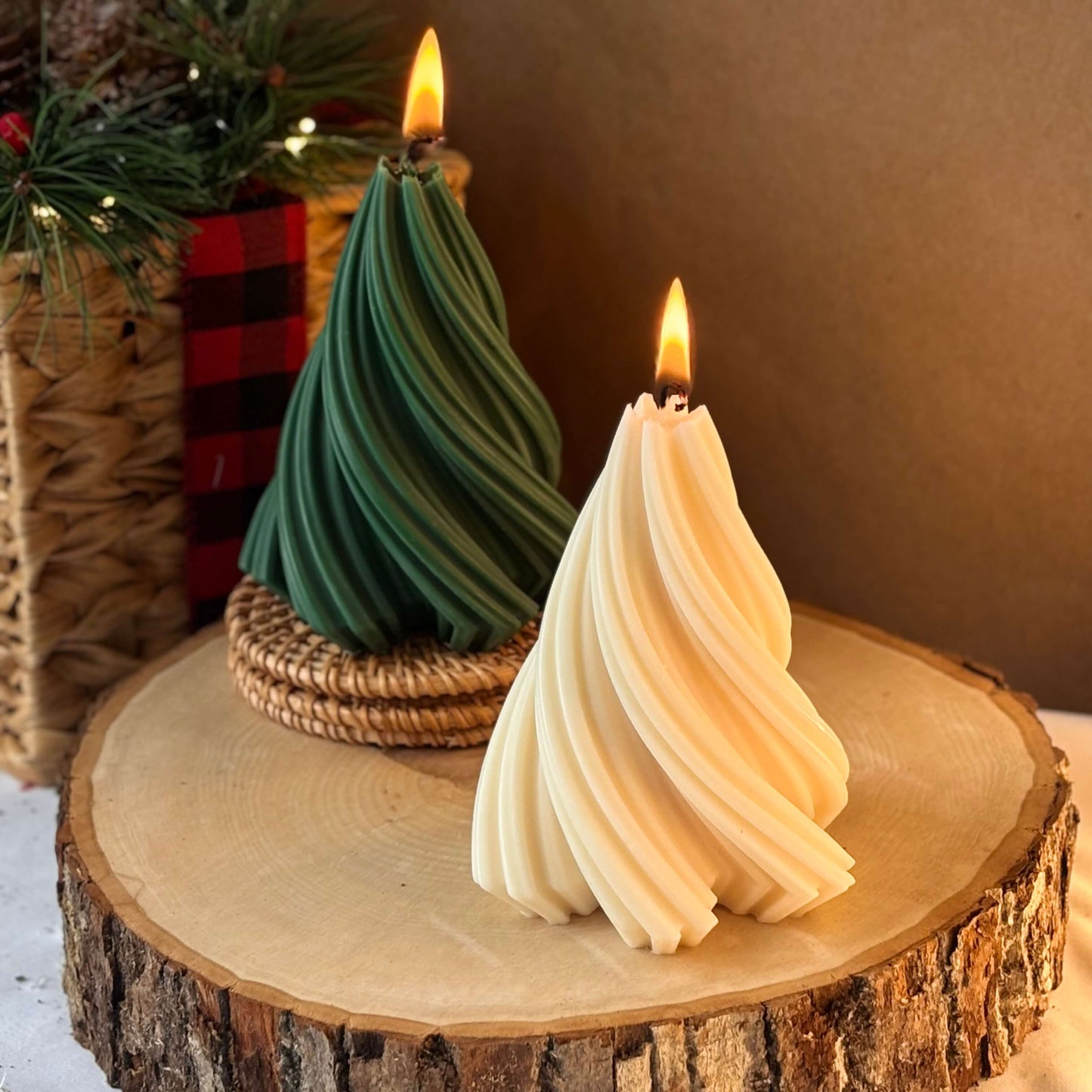 Two soy wax tree candles lit on a rustic wooden slab, styled for cozy handmade Christmas home decoration.