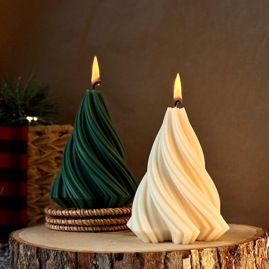 Tree-shaped soy candles in green and ivory colors burning on a wood slice, perfect for Christmas home decor or holiday gifting.