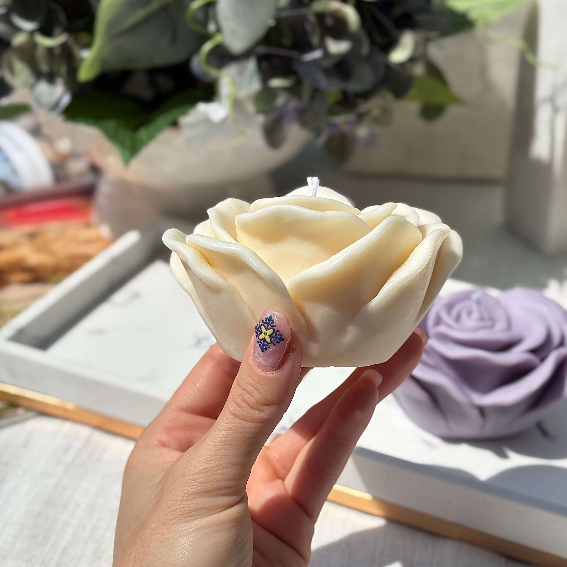 Handmade cream rose candle held in hand, soy wax floral decorative candle for gifts