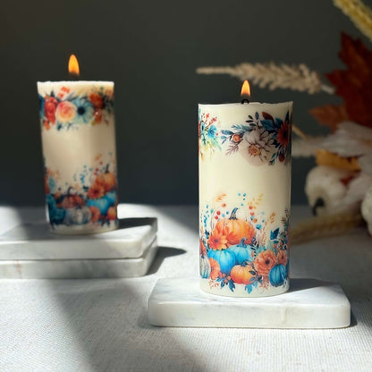 Diamond glossy pumpkin candles glowing with autumn floral design on marble base