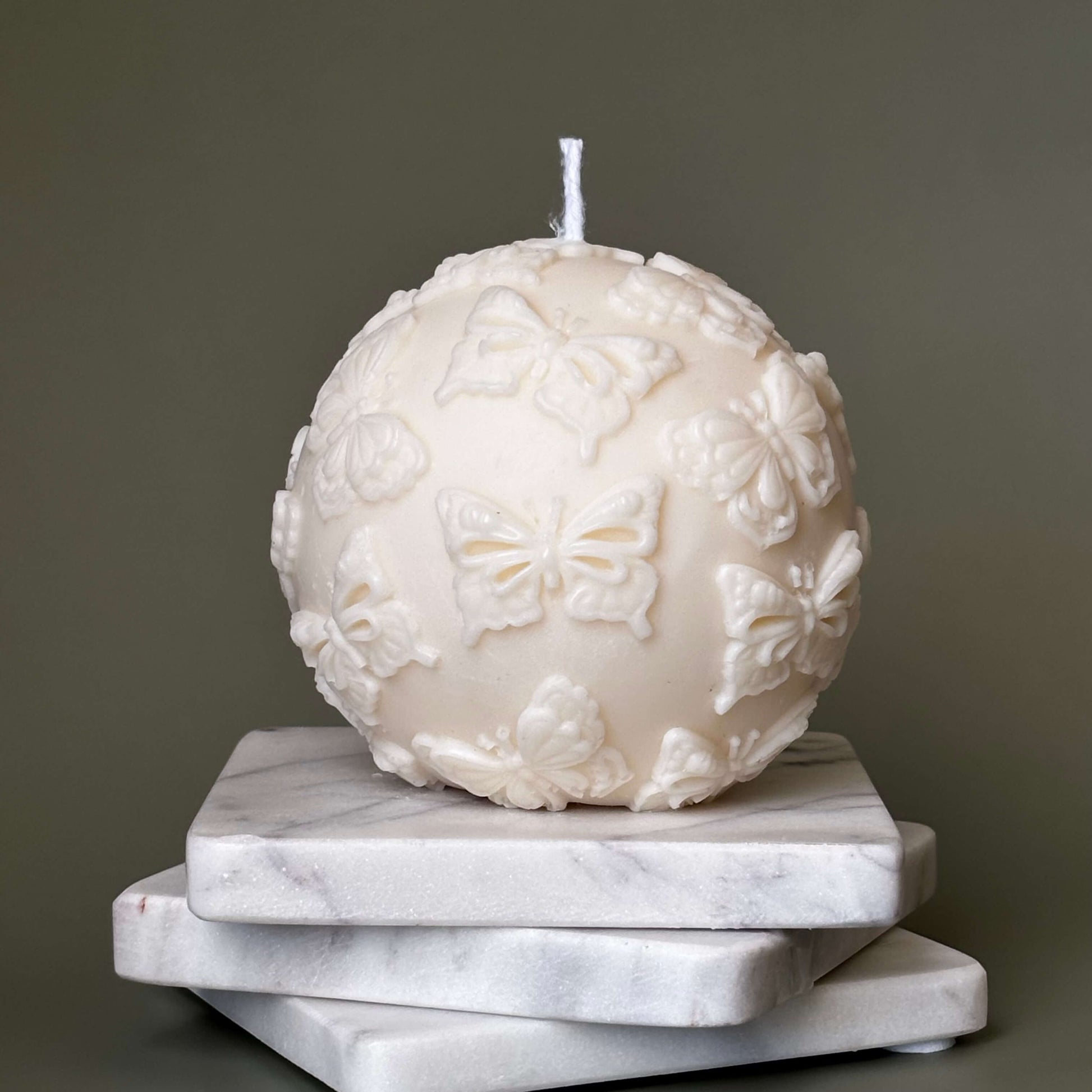Eco-friendly soy candle in sphere form with butterfly design
