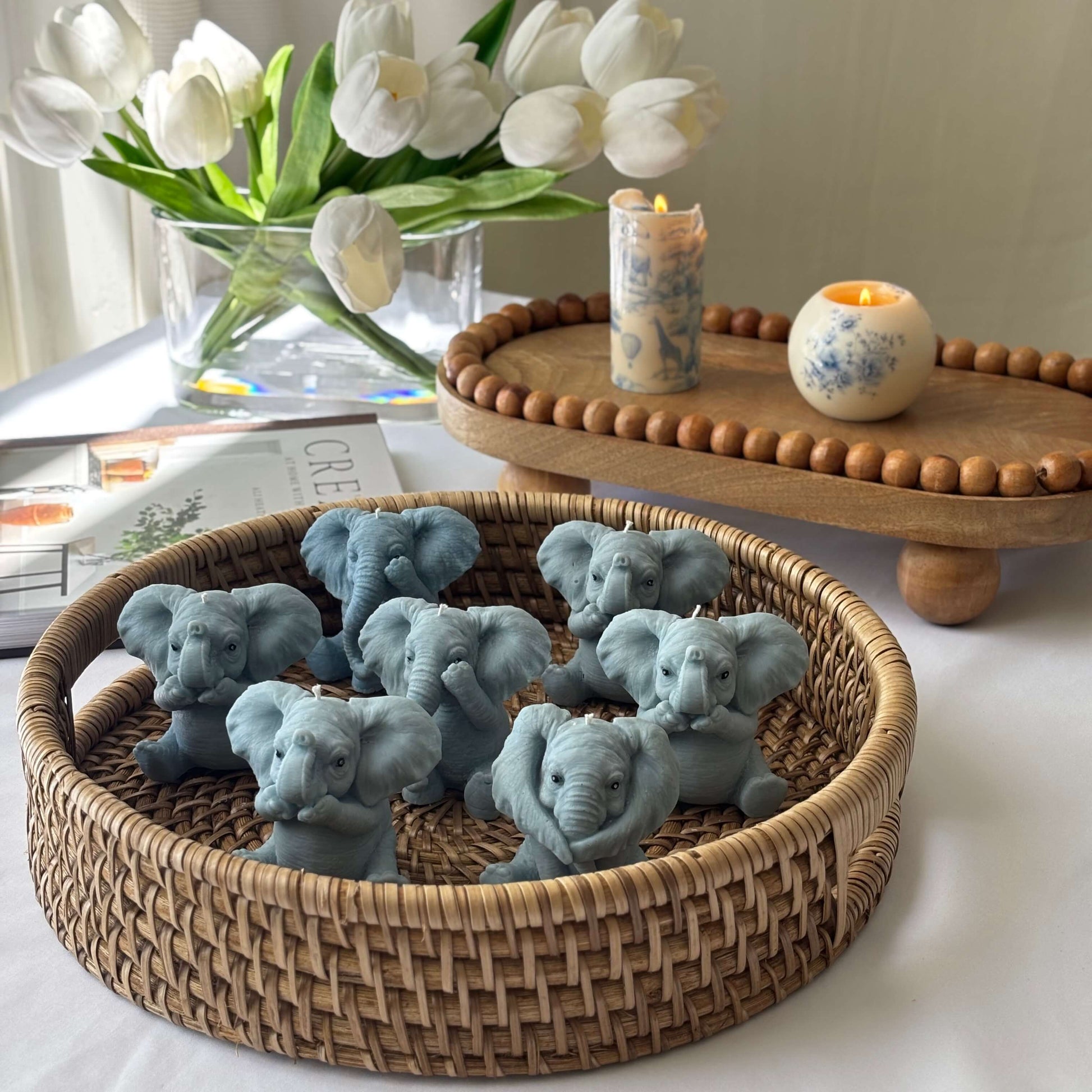 Handmade soy wax elephant candles arranged in a giftable basket set, ideal for decor, animal lovers, or baby showers.
