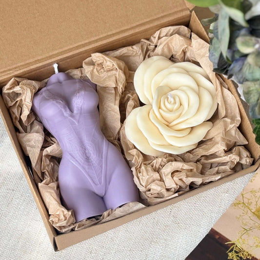 Handmade soy wax gift set with purple female torso candle and cream rose candle in decorative box