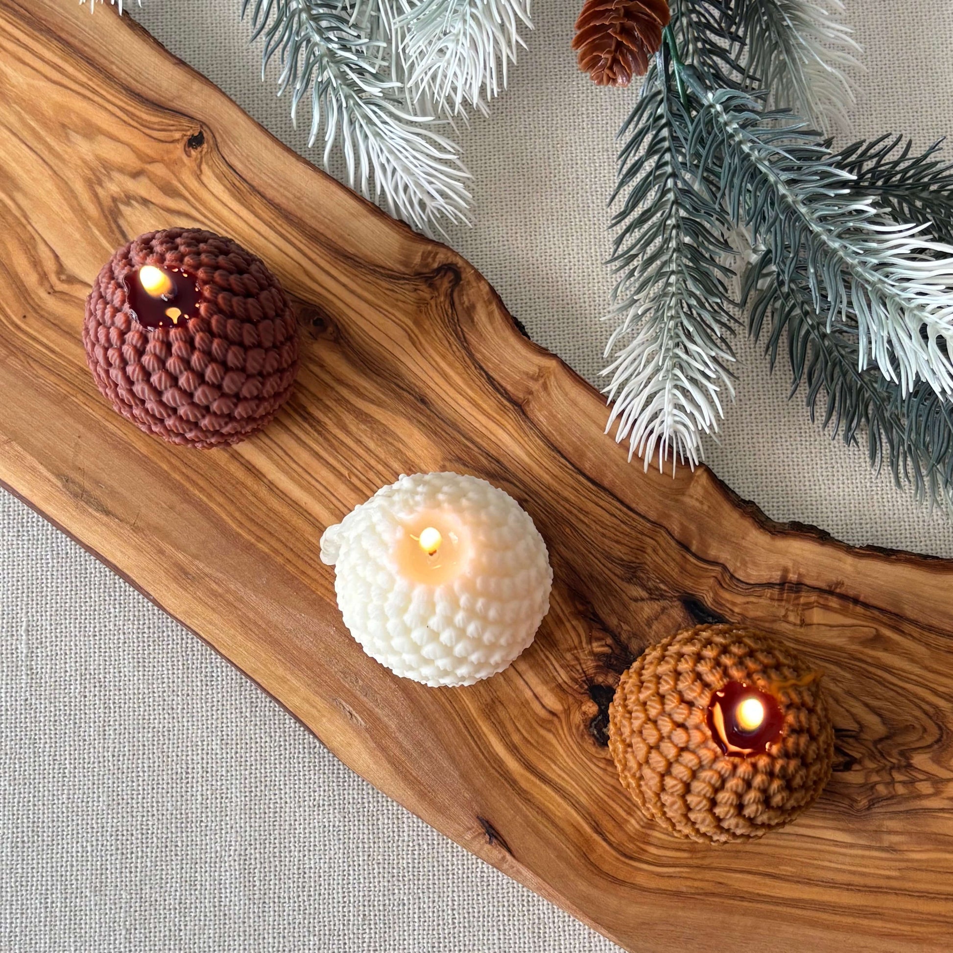 Holiday decorative candle shaped like a pinecone, handmade soy wax design for cozy décor