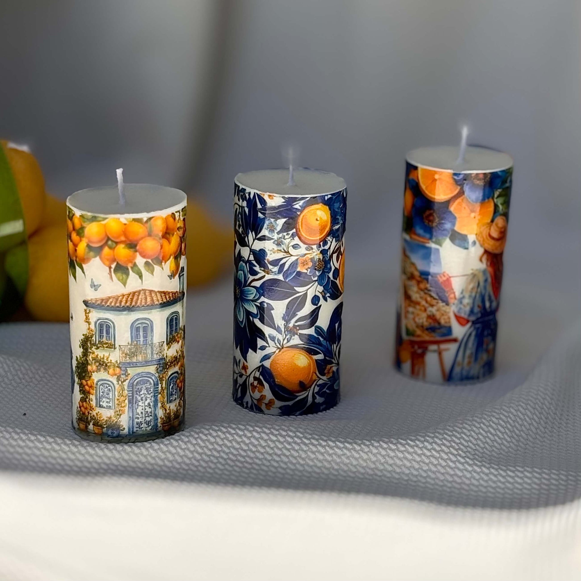 Decorative Italian-style candles with lemon house, floral prints and Mediterranean ceramic art