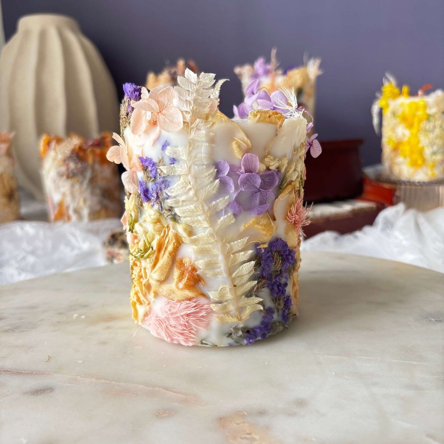 Handmade lilac soy wax candle with dried flowers for gifting and home decor