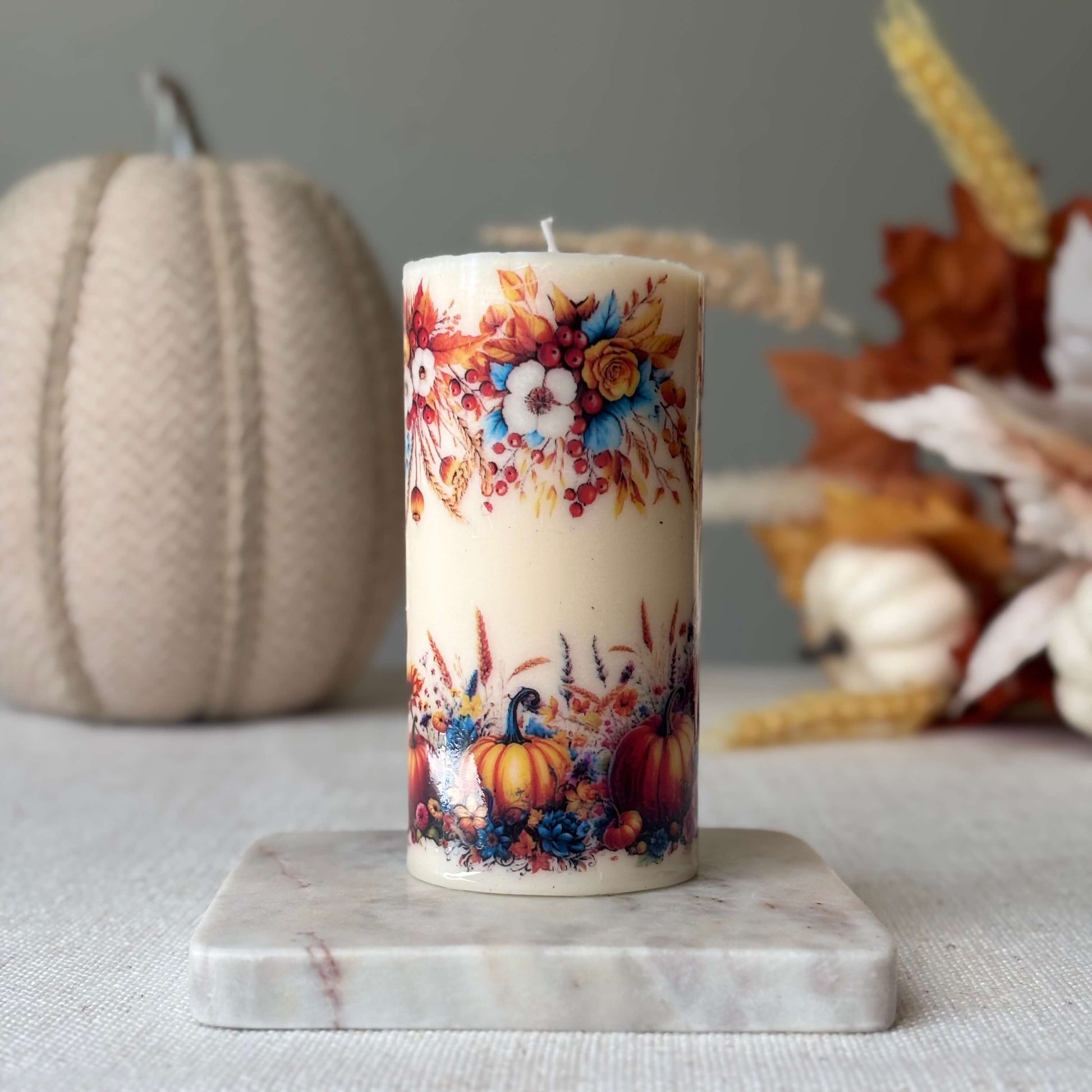 Seasonal pumpkin holiday candle with autumn harvest flowers, perfect handmade fall décor, Thanksgiving table centerpiece, and holiday gift idea.