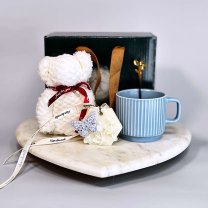 Luxury gift box featuring a plush teddy towel, ceramic coffee mug, gold spoon, and handcrafted wax sachet with dried flowers and butterfly — perfect for self-care, thank you gifts, or cozy moments
