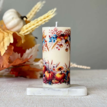 Handmade autumn pumpkin candle on marble base with harvest floral pattern, perfect for Thanksgiving centerpiece and cozy fall holiday décor.