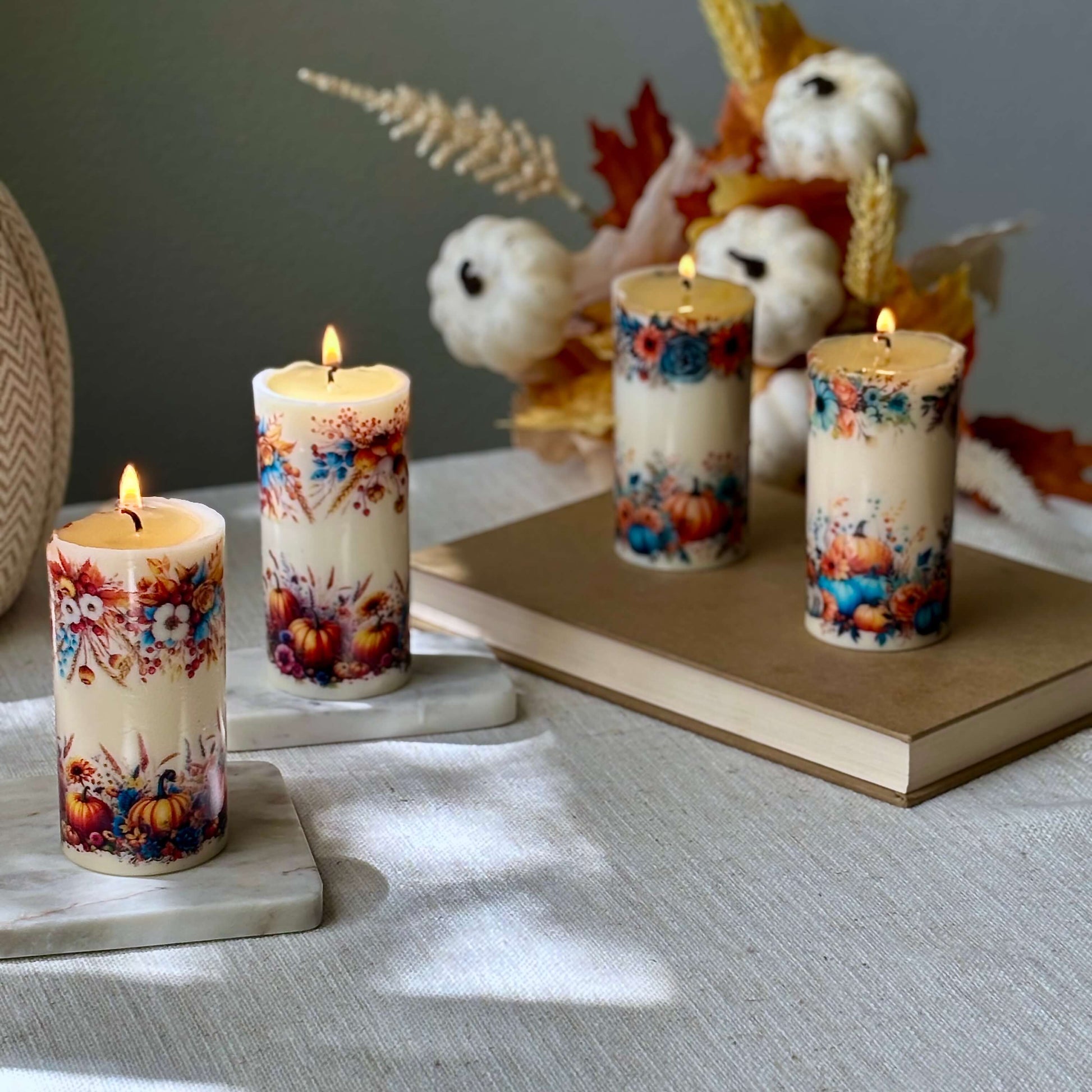 Set of handmade pumpkin holiday candles with floral harvest design, fall centerpiece for Thanksgiving dinner table and holiday home décor.