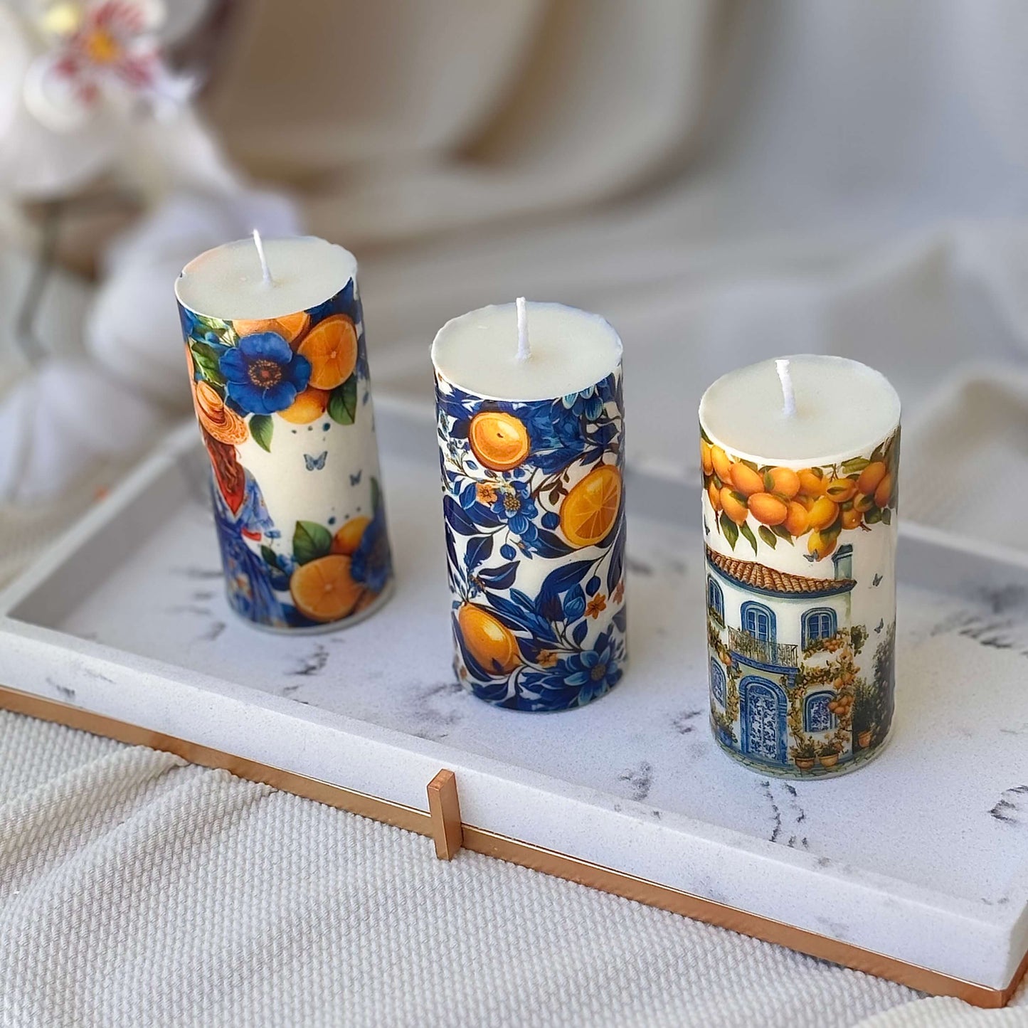 Handmade Mediterranean candles with citrus art and toile de jouy blue flowers on marble tray


